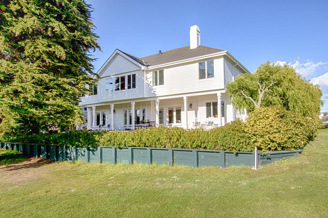 2140 Winged Foot Road Half Moon Bay, CA 94019 - Photo 39 of 52 a front view of a house with a yard and trees