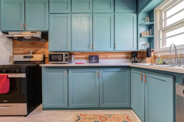 a kitchen with stainless steel appliances granite countertop cabinets and a sink