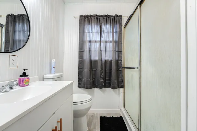 a bathroom with a sink toilet and shower