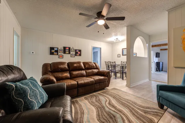 a living room with furniture and a chandelier
