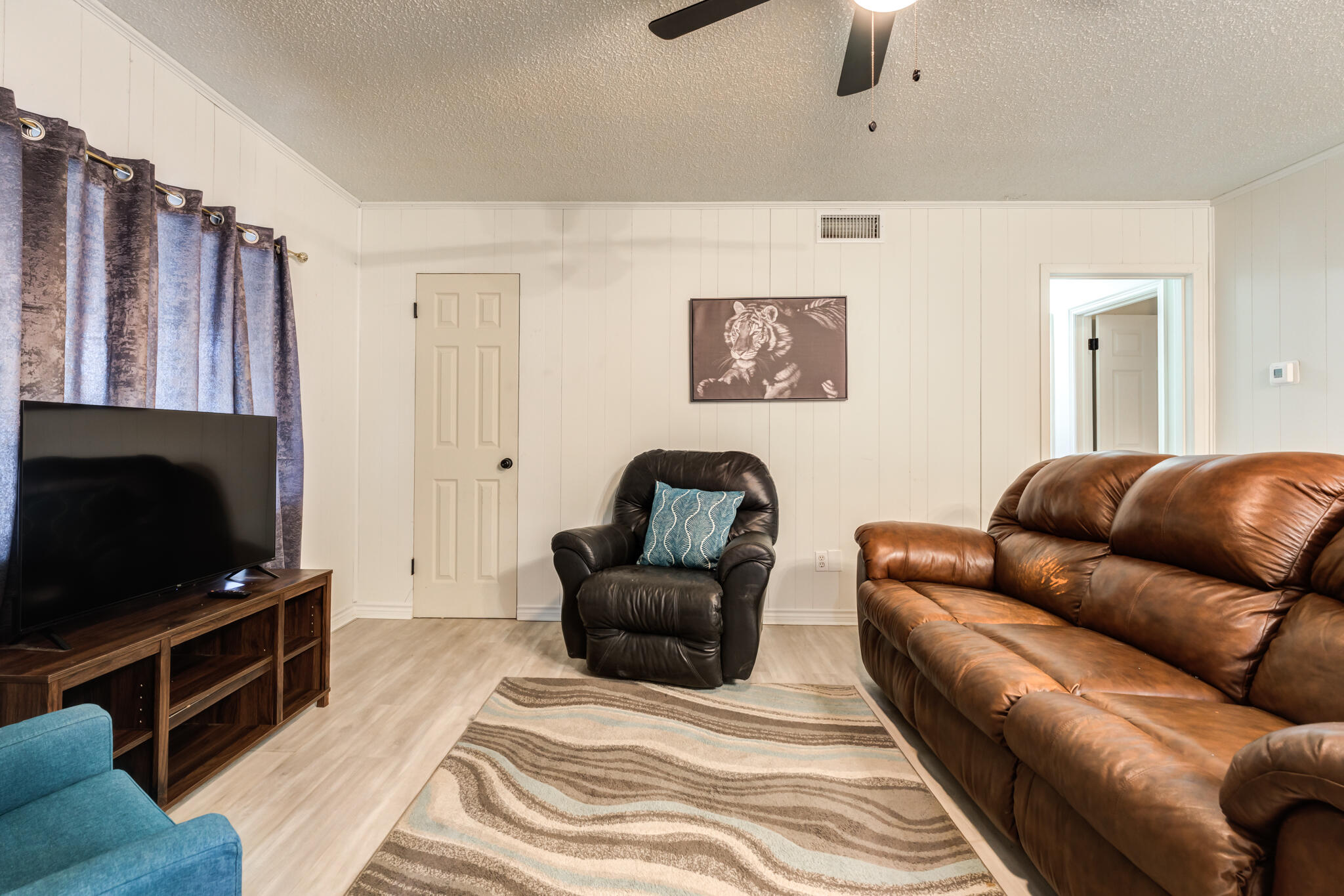 4612 Canton Avenue Lubbock, TX 79413 - Photo 5 of 15 a living room with furniture and a flat screen tv