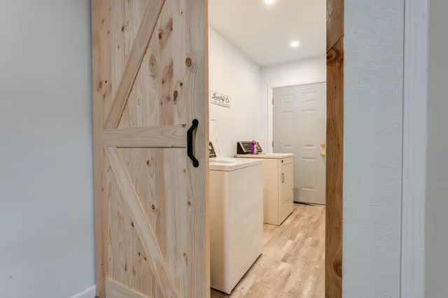 a bathroom with a sink a toilet a mirror and shower