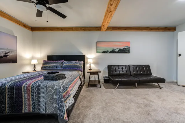 a bedroom with a bed and a couch