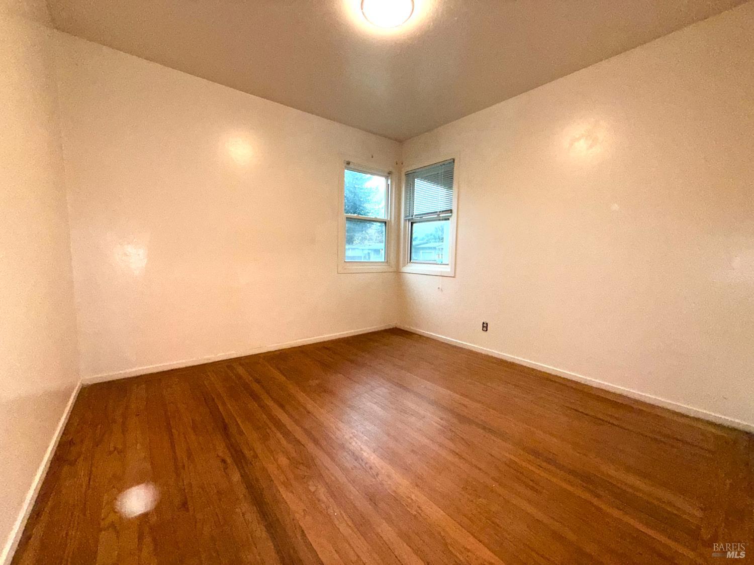 3469 Idaho Drive Santa Rosa, CA 95405 - Photo 21 of 31 BEDROOM #3 - Carpet has been removed to reveal original wood floors which are in average condition and worn, need to be re-finished. The home was re-leveled in December 2025, settlement cracks (in earlier photos) have been patched and walls touched up.