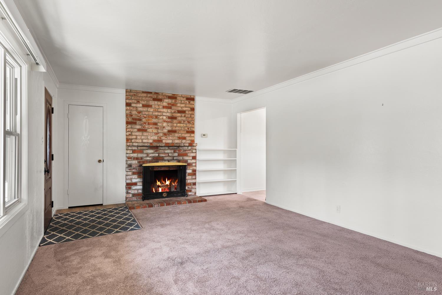 3469 Idaho Drive Santa Rosa, CA 95405 - Photo 7 of 31 Professional photos taken in August 2025 prior to carpet removal and re-leveling of home. Fire in fireplace was photo-shopped in by photographer.