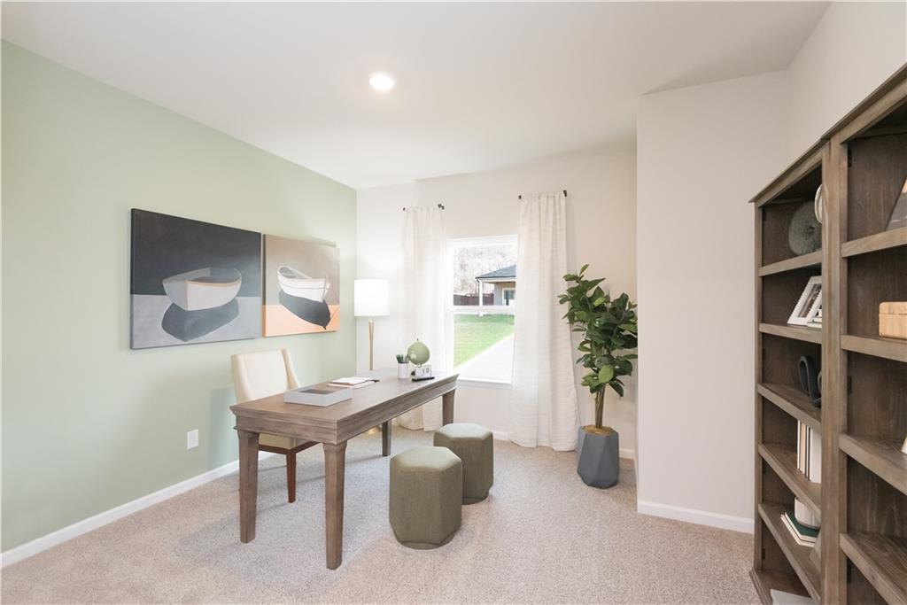 3940 Ladiga Street Powder Springs, GA 30127 - Photo 15 of 31 a living room with furniture and a book shelf