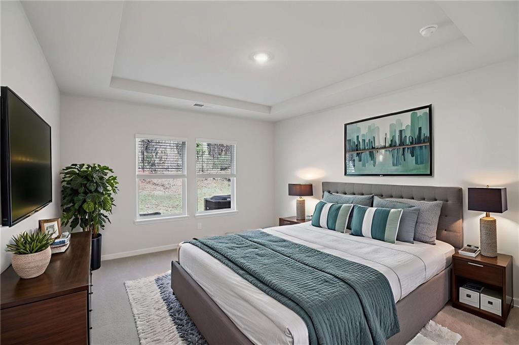 3940 Ladiga Street Powder Springs, GA 30127 - Photo 18 of 31 a spacious bedroom with a bed and a potted plant