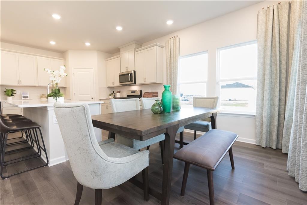 3940 Ladiga Street Powder Springs, GA 30127 - Photo 5 of 31 a view of a dining room with furniture window and wooden floor