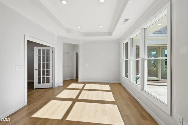 a view of a kitchen with kitchen island a counter top space a sink stainless steel appliances and cabinets