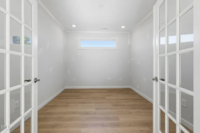 wooden floor in an empty room with a window