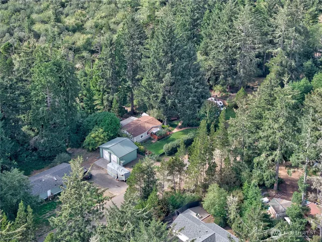 an aerial view of a house with a yard