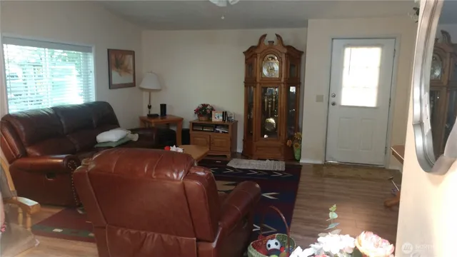 a living room with furniture a window and a dining table