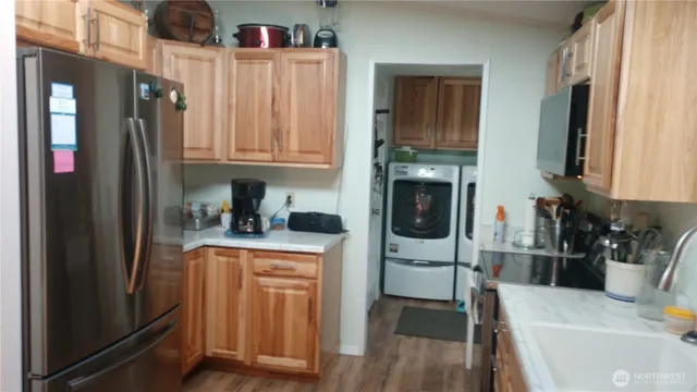 a kitchen with stainless steel appliances granite countertop a refrigerator and a sink