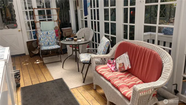 a view of a livingroom with furniture and a floor to ceiling window