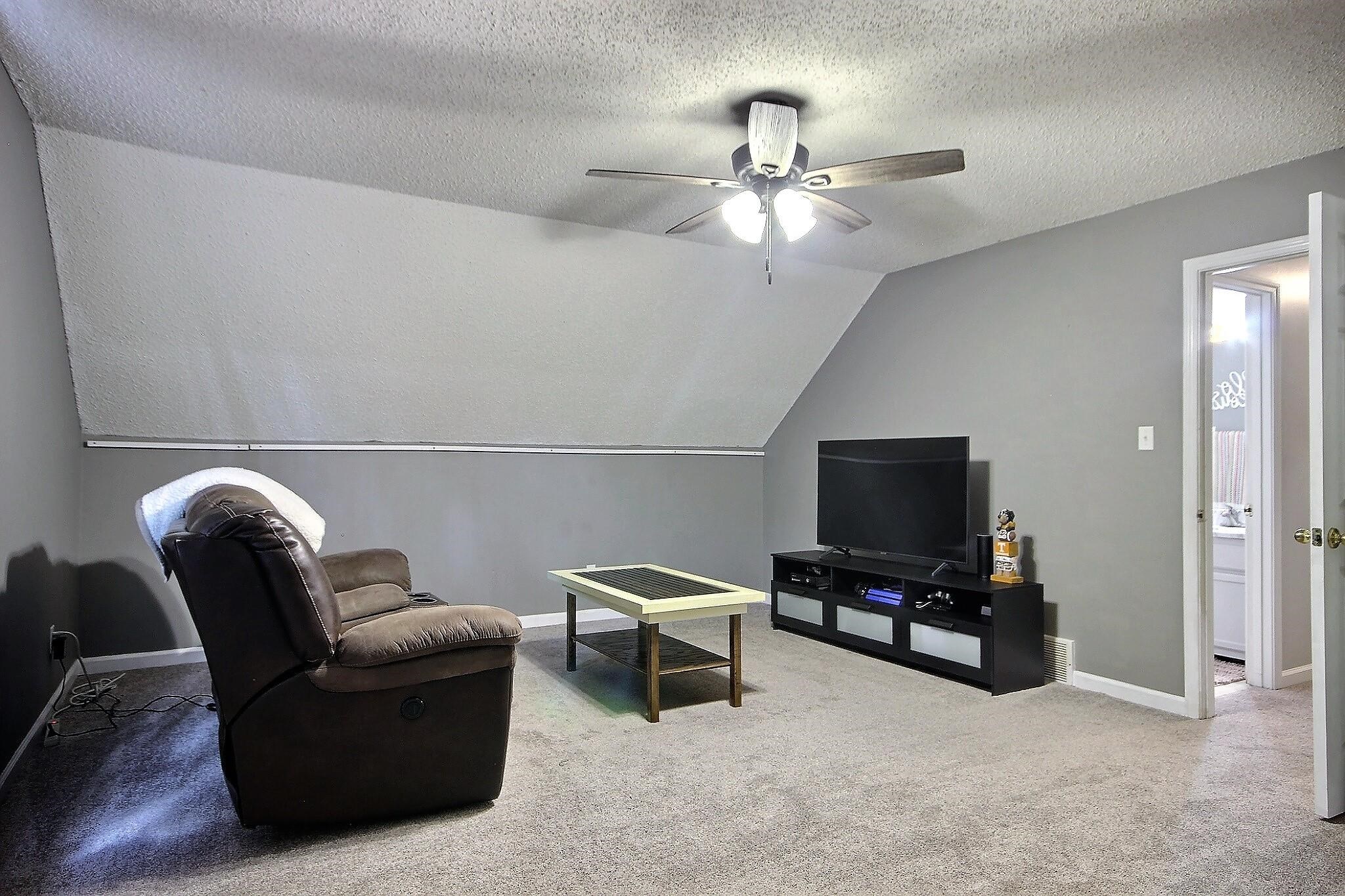 556 Rillbrook Drive Collierville, TN 38017 - Photo 19 of 22 a living room with furniture and a flat screen tv
