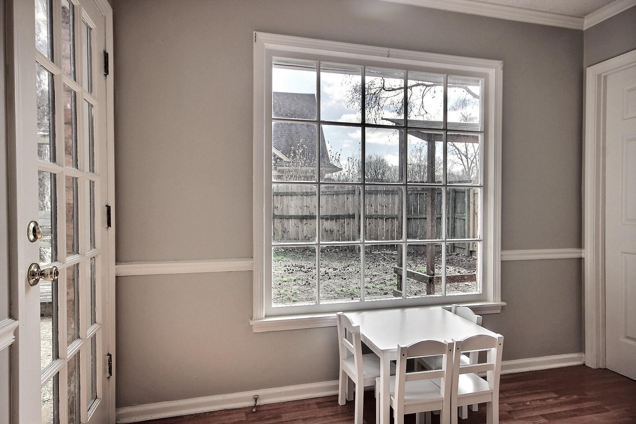 556 Rillbrook Drive Collierville, TN 38017 - Photo 7 of 22 a dining room with wooden floor and windows