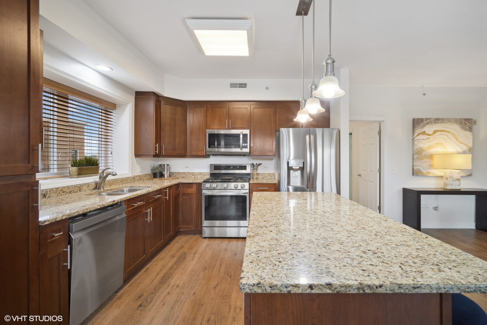 799 Graceland Avenue, Unit 502A Des Plaines, IL 60016 - Photo 13 of 31 a large kitchen with granite countertop a large counter top stainless steel appliances and cabinets