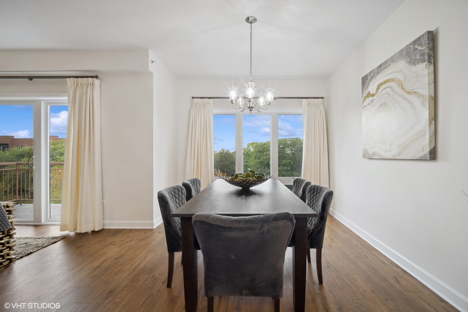 799 Graceland Avenue, Unit 502A Des Plaines, IL 60016 - Photo 16 of 31 a view of a dining room with furniture wooden floor and chandelier