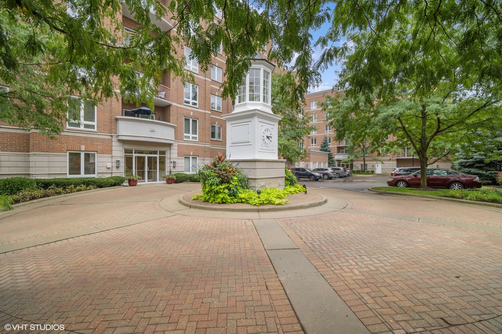 799 Graceland Avenue, Unit 502A Des Plaines, IL 60016 - Photo 2 of 31 a front view of a house with a yard and fountain
