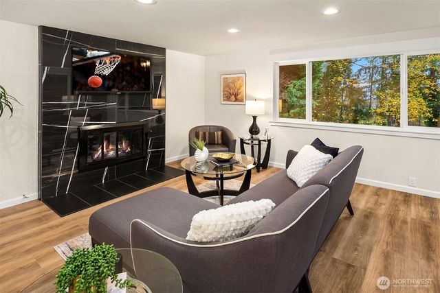 a living room with furniture and a floor to ceiling window