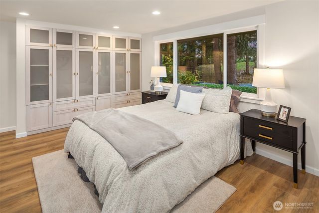 a bed room with a bed and a large window