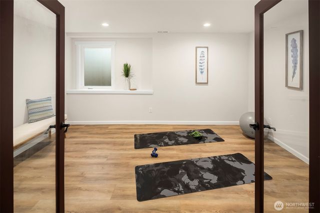 a view of a bedroom with wooden floor and furniture