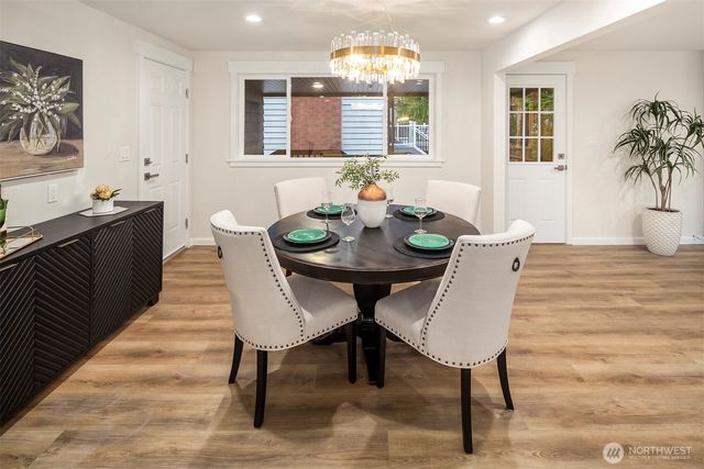 a view of a dining room with furniture and wooden floor