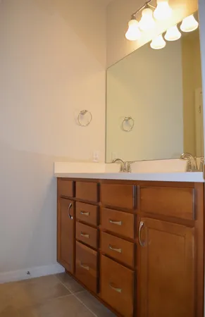 a bathroom with a sink vanity and a mirror