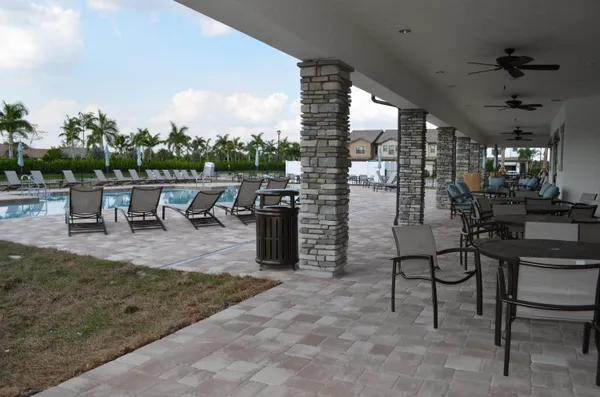 a view of a porch with chairs and backyard
