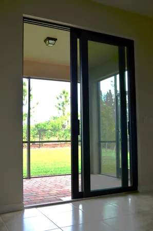 a view of a room with a large window and wooden floor