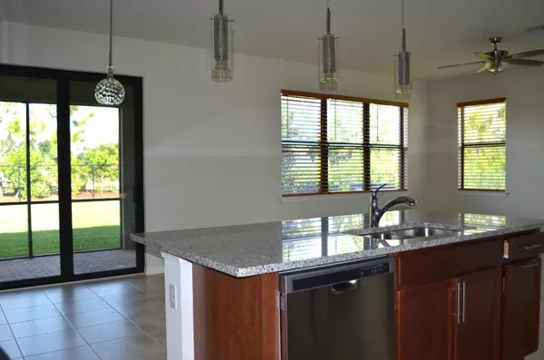 a kitchen with granite countertop a sink and a window