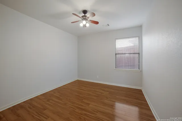 a view of a room with wooden floor and a window