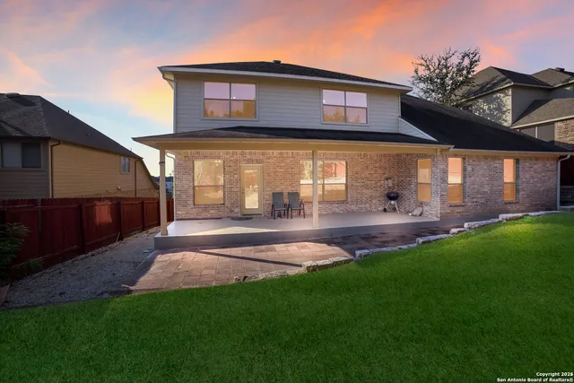 a view of a house with a backyard