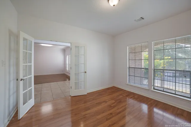 wooden floor in an empty room with a window