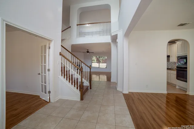 a view of a hallway with wooden floor and staircase