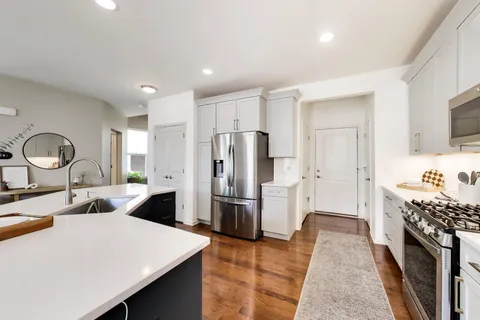 a spacious bedroom with a bed and a flat screen tv