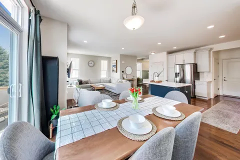 a kitchen with white cabinets sink and stainless steel appliances