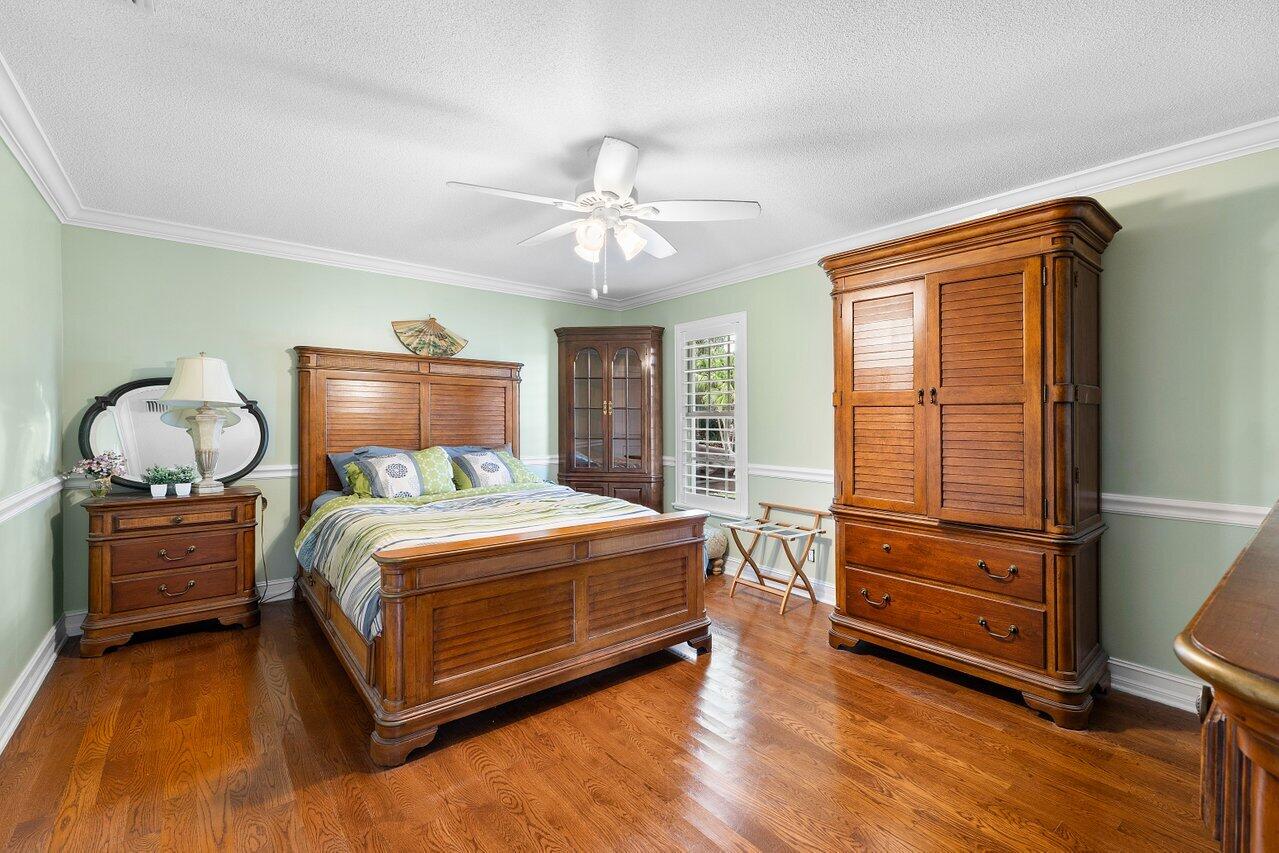 16467 Brookfield Estates Way Delray Beach, FL 33446 - Photo 36 of 78 a bedroom with a bed and wooden floor