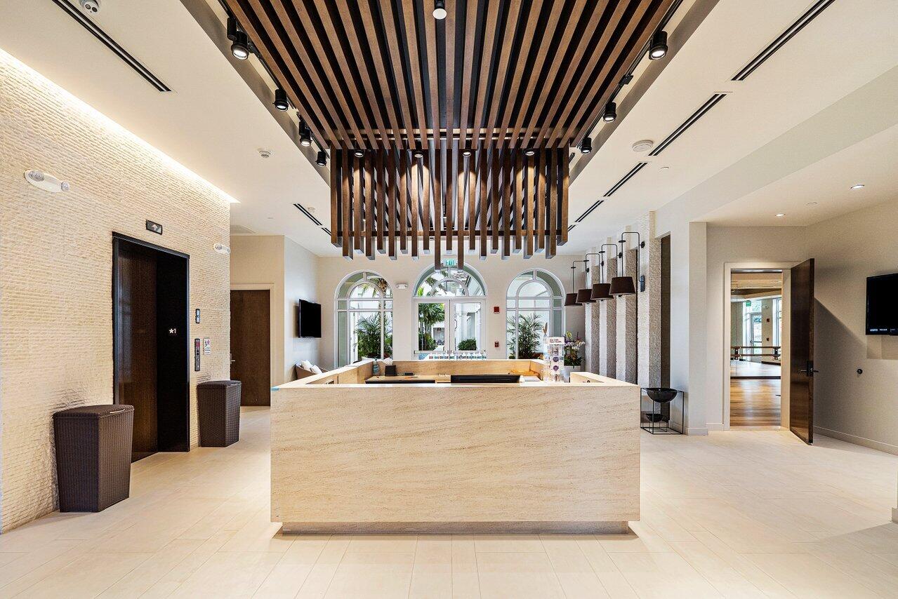 16467 Brookfield Estates Way Delray Beach, FL 33446 - Photo 58 of 78 a large white kitchen with a large counter top and stainless steel appliances