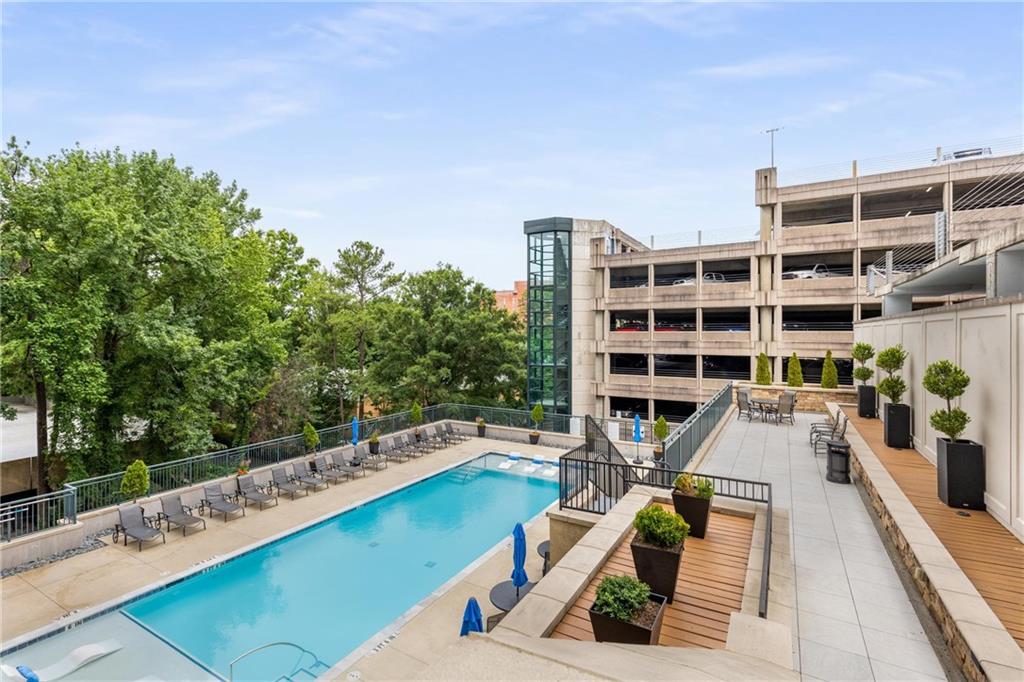 3040 Peachtree Road, Unit 1205 Atlanta, GA 30305 - Photo 20 of 43 a view of a balcony with wooden floor and potted plants
