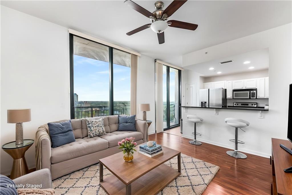 3040 Peachtree Road, Unit 1205 Atlanta, GA 30305 - Photo 2 of 43 a living room with furniture and a large window