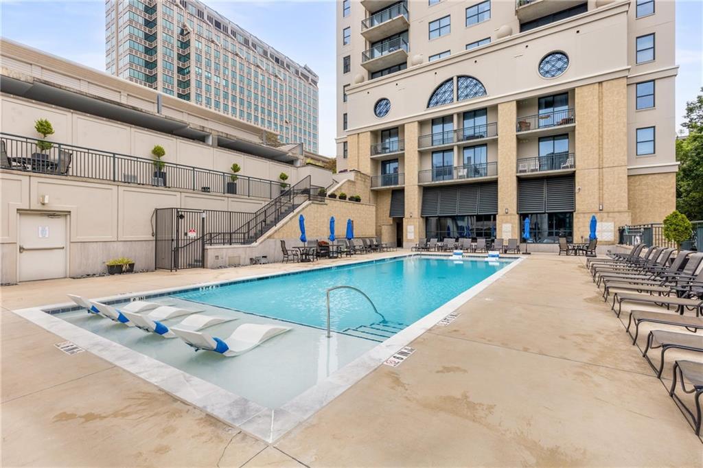 3040 Peachtree Road, Unit 1205 Atlanta, GA 30305 - Photo 21 of 43 a view of a swimming pool with a lounge chairs