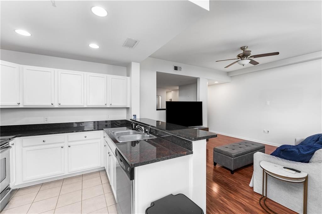 3040 Peachtree Road, Unit 1205 Atlanta, GA 30305 - Photo 4 of 43 a kitchen with a sink a stove and cabinets