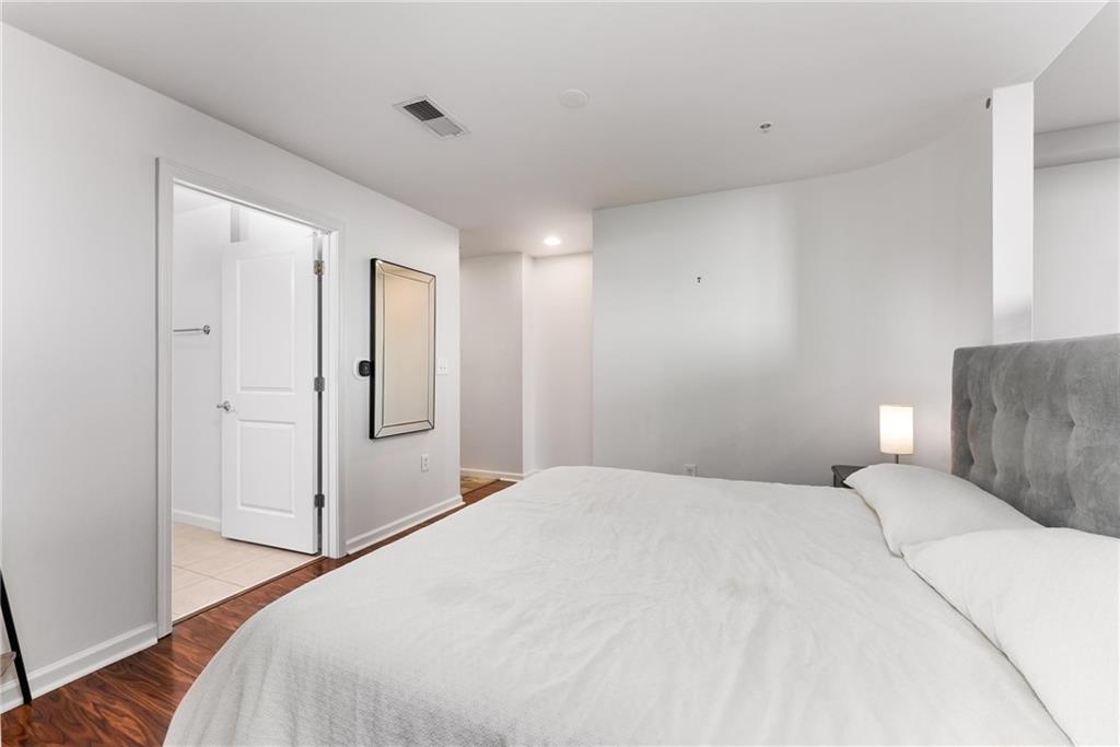 3040 Peachtree Road, Unit 1205 Atlanta, GA 30305 - Photo 9 of 43 a bedroom with a bed and a mirror