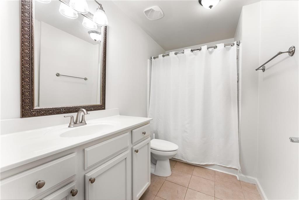 3040 Peachtree Road, Unit 1205 Atlanta, GA 30305 - Photo 10 of 43 a bathroom with a sink a toilet and a mirror