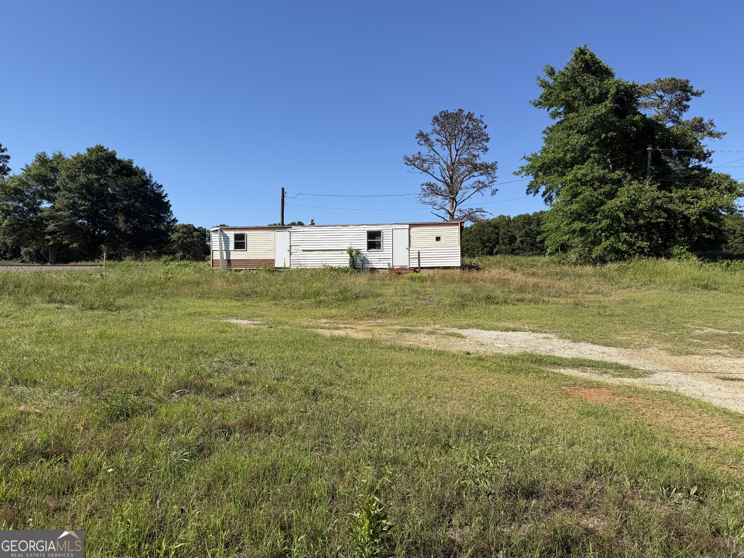 265 Aldora Street Barnesville, GA 30204 - Photo 1 of 9 a view of a big yard with a house