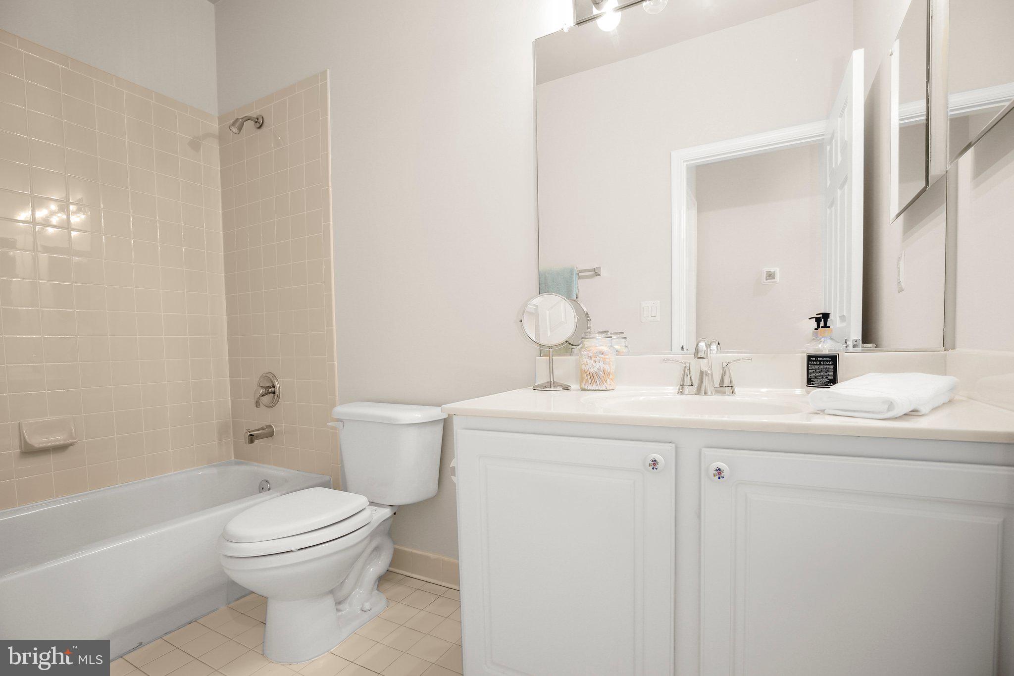 14 Sugargrove Court Fredericksburg, VA 22406 - Photo 28 of 63 a bathroom with a toilet a sink a mirror a bathtub and vanity