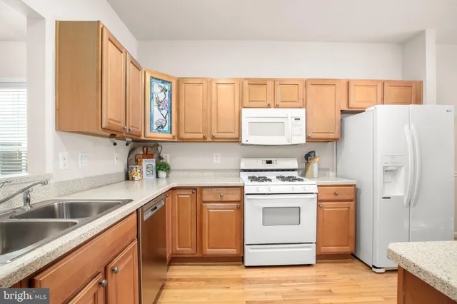 a kitchen with a refrigerator sink and cabinets