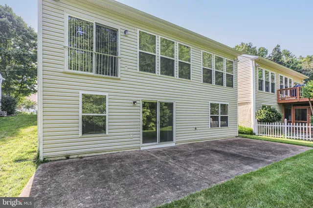 a living room with a table chairs and a chandelier