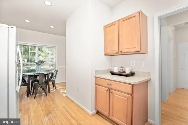 a kitchen with appliances cabinets and wooden floor